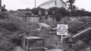 An image of Africville with a sign advising residents to boil water before drinking